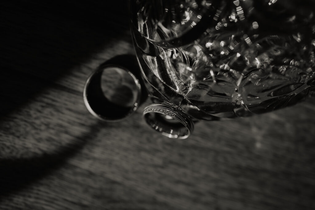 Trouwuitnodiging Rick en Amber met gouden trouwringen op houten tafel, creatieve detailfoto trouwfotografie Kasteel Ruurlo